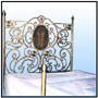 An extended version of CODE 0786/011/002; with brass and richer motif work. It is available with or without a matching footboard and stands if desired. Sizes: W : 6'  H : 6.5'  WT : 125 lbs (Bed Head)  