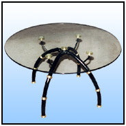 Round Center table      A tubular brass table with knots and a rather unorthodox shape. We have marketed this piece quite successfully. Table complete with a 6mm round glass.     Sizes: H : 18" Dia : 24"  WT : 27 lbs (Without Glass Top).     Entire profile; Segmental fabrication in 11/4" Tubing with brass separators.  